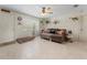Living room with tile floors, ceiling fan, neutral colors, and large window at 1620 Carolyn Ct, St Cloud, FL 34769