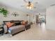 An open-concept living room with tile flooring, a ceiling fan, and a comfortable sofa at 1620 Carolyn Ct, St Cloud, FL 34769