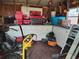 Image shows the inside of the shed, revealing ample storage space, cabinets, and tools neatly organized at 1620 Carolyn Ct, St Cloud, FL 34769