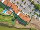 Overhead view of a condo building with a pool, parking area, and landscaping by the lake at 16300 County Road 455 # 405, Montverde, FL 34756