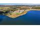 Stunning aerial view of lakeside condos with lush landscaping and community pool at 16300 County Road 455 # 405, Montverde, FL 34756