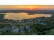 Majestic sunset aerial view highlights this luxury home community, with a beautiful lake as the backdrop at 16300 County Road 455 # 405, Montverde, FL 34756
