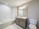 Modern bathroom featuring a bathtub, a white subway tile shower, and sleek vanity with storage at 16300 County Road 455 # 405, Montverde, FL 34756