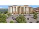 Multi-story condo building featuring a large parking lot with ample parking spaces and nearby lake views at 16300 County Road 455 # 405, Montverde, FL 34756