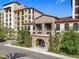 Multi-story building with stone accents, a tiled roof, landscaped grounds and well-maintained exterior at 16300 County Road 455 # 405, Montverde, FL 34756