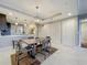 Dining area with modern lighting, adjacent to the kitchen, featuring a table with seating for four at 16300 County Road 455 # 405, Montverde, FL 34756