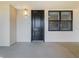 Condo entrance featuring a black door, unit number, window, and lighting fixture on a neutral wall at 16300 County Road 455 # 405, Montverde, FL 34756
