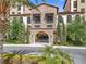 Beautiful multi-story building with stone accents and landscaped front entrance and trimmed shrubs at 16300 County Road 455 # 405, Montverde, FL 34756