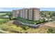 Beautiful exterior shot of a condo complex overlooking scenic landscaping and a lake at 16300 County Road 455 # 405, Montverde, FL 34756