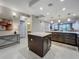 Kitchen island featuring white countertops and dark wood cabinets with storage throughout open spaces at 16300 County Road 455 # 405, Montverde, FL 34756