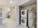 An interior laundry room is shown with a washing machine, dryer, and water heater at 16300 County Road 455 # 405, Montverde, FL 34756