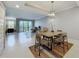 Bright open living and dining area with tile floors, and natural light from the sliding glass doors at 16300 County Road 455 # 405, Montverde, FL 34756