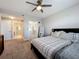 Comfortable bedroom featuring a ceiling fan, walk-in closet, en-suite bath, and neutral tones for a serene ambiance at 16300 County Road 455 # 405, Montverde, FL 34756