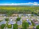 Scenic aerial view of a suburban neighborhood near a lush forest, showcasing the homes' proximity to nature at 20446 Macon Pkwy, Orlando, FL 32833