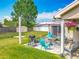 Backyard featuring a patio area with barbecue grill, seating, a shed, and ample green space at 20446 Macon Pkwy, Orlando, FL 32833