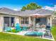 The backyard features a patio with furniture, grill, lush lawn, and string lights for ambiance at 20446 Macon Pkwy, Orlando, FL 32833