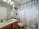 Well-lit bathroom featuring a modern vanity, toilet, and shower with a stylish curtain at 20446 Macon Pkwy, Orlando, FL 32833