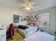 Bright bedroom with a ceiling fan, whimsical decorations and a large window allowing for natural light at 20446 Macon Pkwy, Orlando, FL 32833