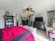 Spacious primary bedroom featuring a ceiling fan and a view to an attached on-suite bathroom at 20446 Macon Pkwy, Orlando, FL 32833
