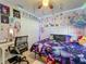 Charming bedroom features a whimsical decor, ambient string lights, and ample storage space with a ceiling fan at 20446 Macon Pkwy, Orlando, FL 32833