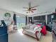 Bright bedroom with a ceiling fan, featuring comfortable seating and access to the outdoors through sliding glass doors at 20446 Macon Pkwy, Orlando, FL 32833