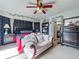 Inviting bedroom featuring a ceiling fan, comfortable seating, and convenient access to an ensuite bathroom at 20446 Macon Pkwy, Orlando, FL 32833