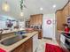 Open kitchen featuring granite countertops, stainless steel appliances, tile floors, and cabinetry at 20446 Macon Pkwy, Orlando, FL 32833