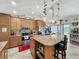 Well-equipped kitchen with a center island, tile floors, pendant lights, and stainless steel appliances at 20446 Macon Pkwy, Orlando, FL 32833