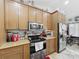 Efficient kitchen with stainless steel appliances, granite countertops, and stylish wooden cabinetry at 20446 Macon Pkwy, Orlando, FL 32833