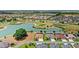 Aerial view showcasing a lake, golf course and houses, complimented by lush landscaping at 2086 Biller Cir, The Villages, FL 32163