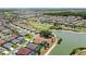 Expansive aerial view showcasing a residential community with mature trees, golf course, and lakefront properties at 2086 Biller Cir, The Villages, FL 32163