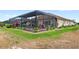 Well-maintained lawn with screened-in lanai, pool, and manicured landscaping at 2086 Biller Cir, The Villages, FL 32163