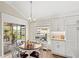 Cozy breakfast nook with sliding glass doors that lead to an outdoor patio with a water view at 2086 Biller Cir, The Villages, FL 32163