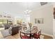 An open-concept dining room offers seamless access to the living room and a view of the backyard at 2086 Biller Cir, The Villages, FL 32163