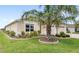 Well-manicured front yard with lush green lawn and a mature palm tree at 2086 Biller Cir, The Villages, FL 32163