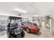 Spacious garage with a car and multiple golf carts at 2086 Biller Cir, The Villages, FL 32163