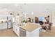 Bright, open kitchen with stainless steel appliances and a large island with pendant lighting at 2086 Biller Cir, The Villages, FL 32163