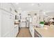 Well-lit kitchen featuring white cabinets, stainless steel appliances, and a spacious center island at 2086 Biller Cir, The Villages, FL 32163