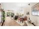 Bright open-concept living area seamlessly integrates a dining space, and outdoor patio with a pool view at 2086 Biller Cir, The Villages, FL 32163