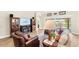 Bright living room with a fireplace, built-in shelving and view of the outdoor pool at 2086 Biller Cir, The Villages, FL 32163