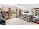 Bright living room with a leather sofa and open window views at 2086 Biller Cir, The Villages, FL 32163