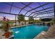 Screened-in pool with a water feature, with picturesque views of the adjacent golf course and pond at 2086 Biller Cir, The Villages, FL 32163