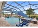 Gorgeous screened-in pool with a spa, lounge chairs and relaxing water views at 2086 Biller Cir, The Villages, FL 32163