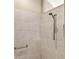 The renovated shower features a hand held shower and grab bar at 2086 Biller Cir, The Villages, FL 32163