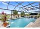 Screened-in pool with water feature, lounge chairs, and views of the water at 2086 Biller Cir, The Villages, FL 32163