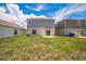 View of the home's backyard with lawn and exterior, showcasing the outdoor space at 264 Hayley St, Winter Haven, FL 33884