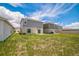The backyard features a lawn and the house's exterior with a sliding glass door at 264 Hayley St, Winter Haven, FL 33884