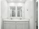 Bathroom features a double sink vanity with quartz countertops and sleek fixtures at 264 Hayley St, Winter Haven, FL 33884