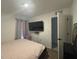 Comfortable bedroom featuring a plush bed, neutral décor, and a television at 264 Hayley St, Winter Haven, FL 33884