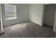 Cozy bedroom featuring soft carpeting, a window with blinds, and a closet at 264 Hayley St, Winter Haven, FL 33884